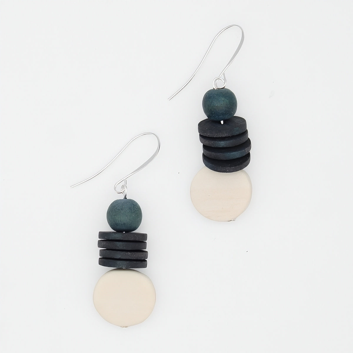 Pair of earrings with stacked black, gray, and white beads on a white background