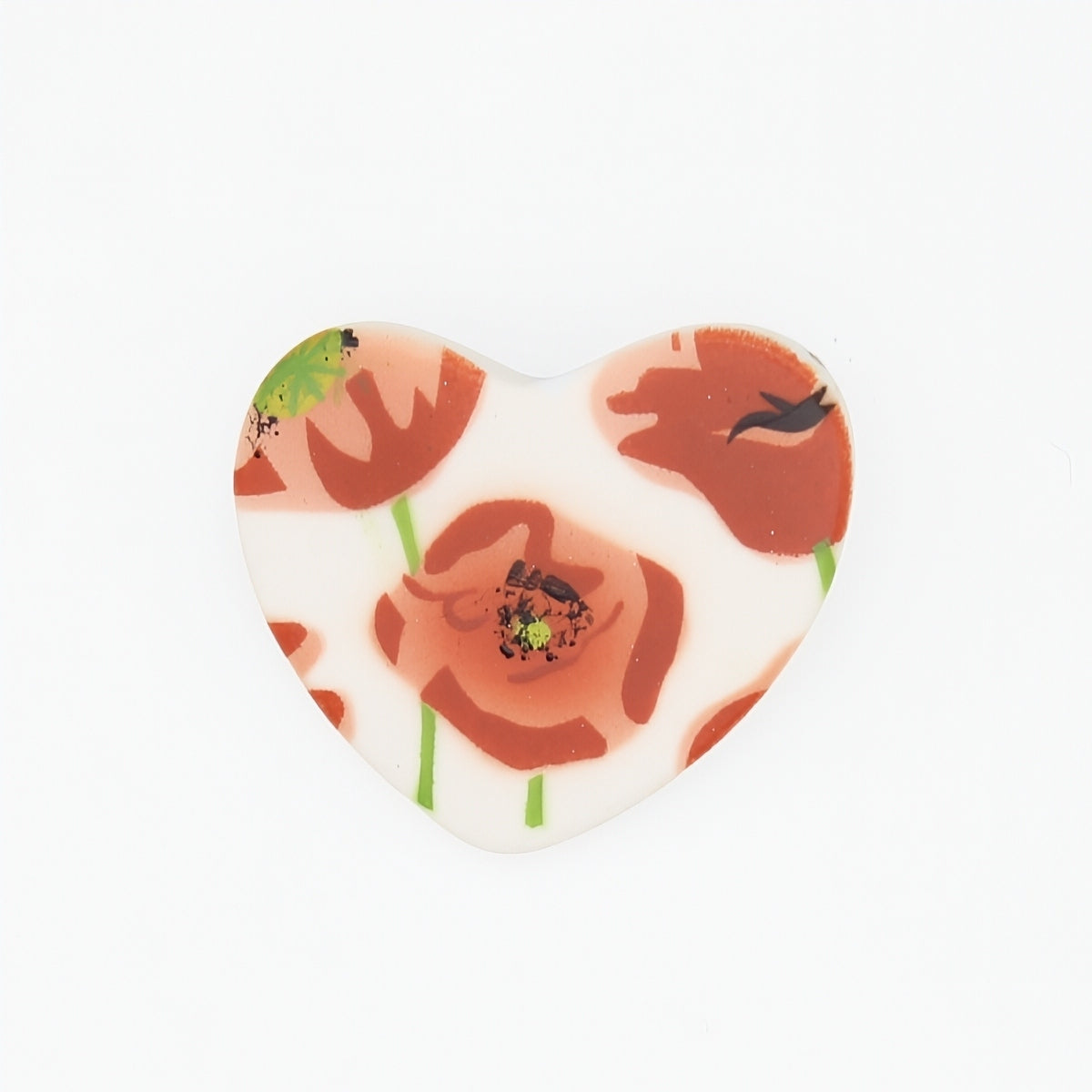 Heart-shaped brooch with floral design on a white background