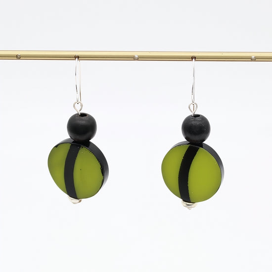 Green and black resin statement earrings hanging display