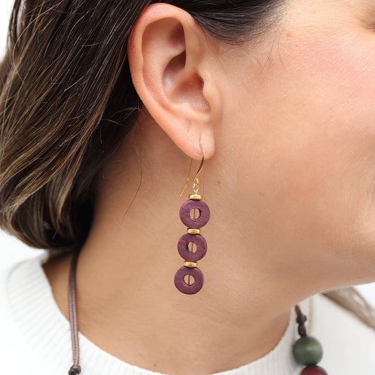 Maroon wood drop earrings shown on model