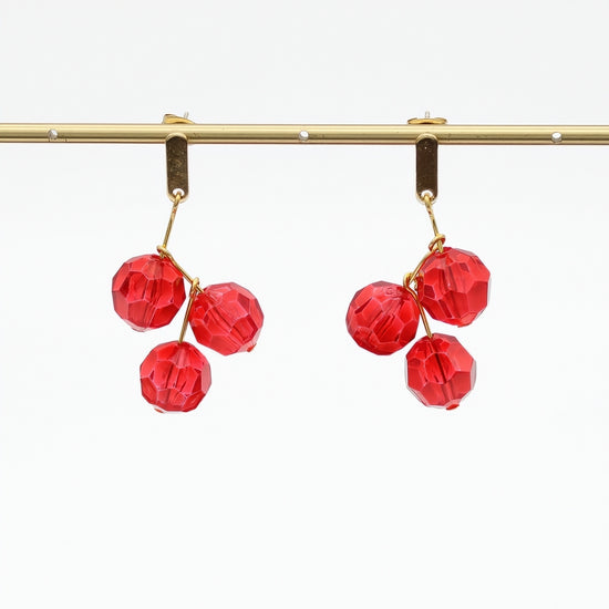 Red faceted bead drop earrings hanging display
