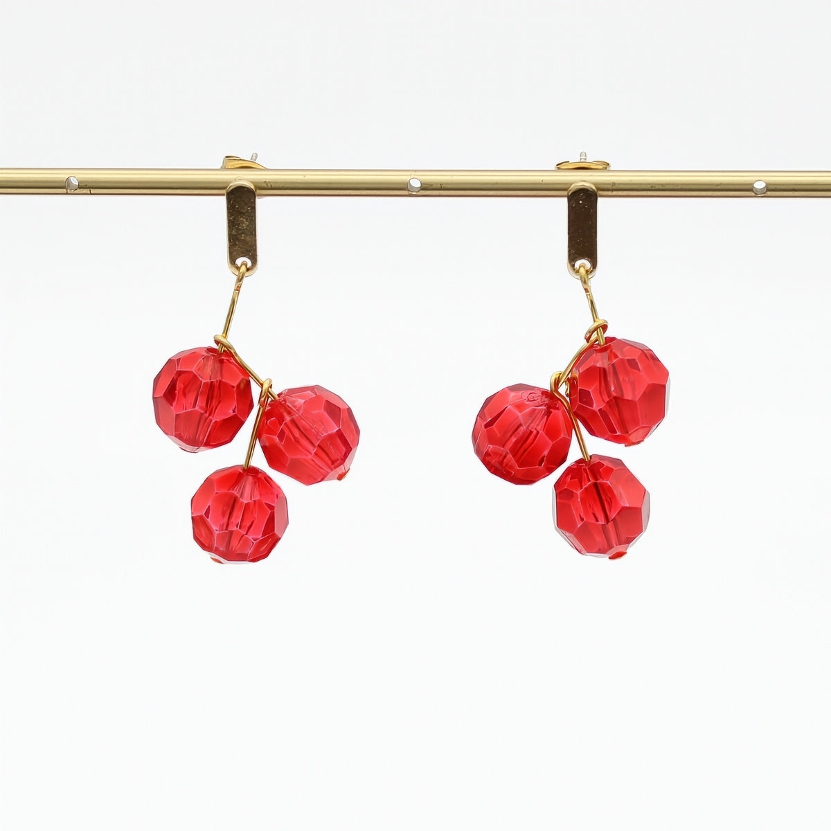 Red faceted bead drop earrings hanging display