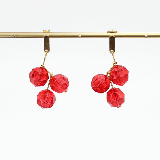 Red faceted bead drop earrings hanging display