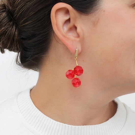 Red faceted bead earrings shown on model