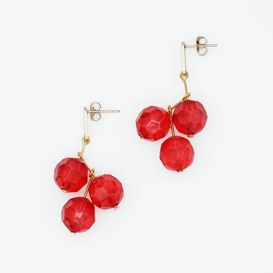 Red faceted bead statement earrings with gold tone post