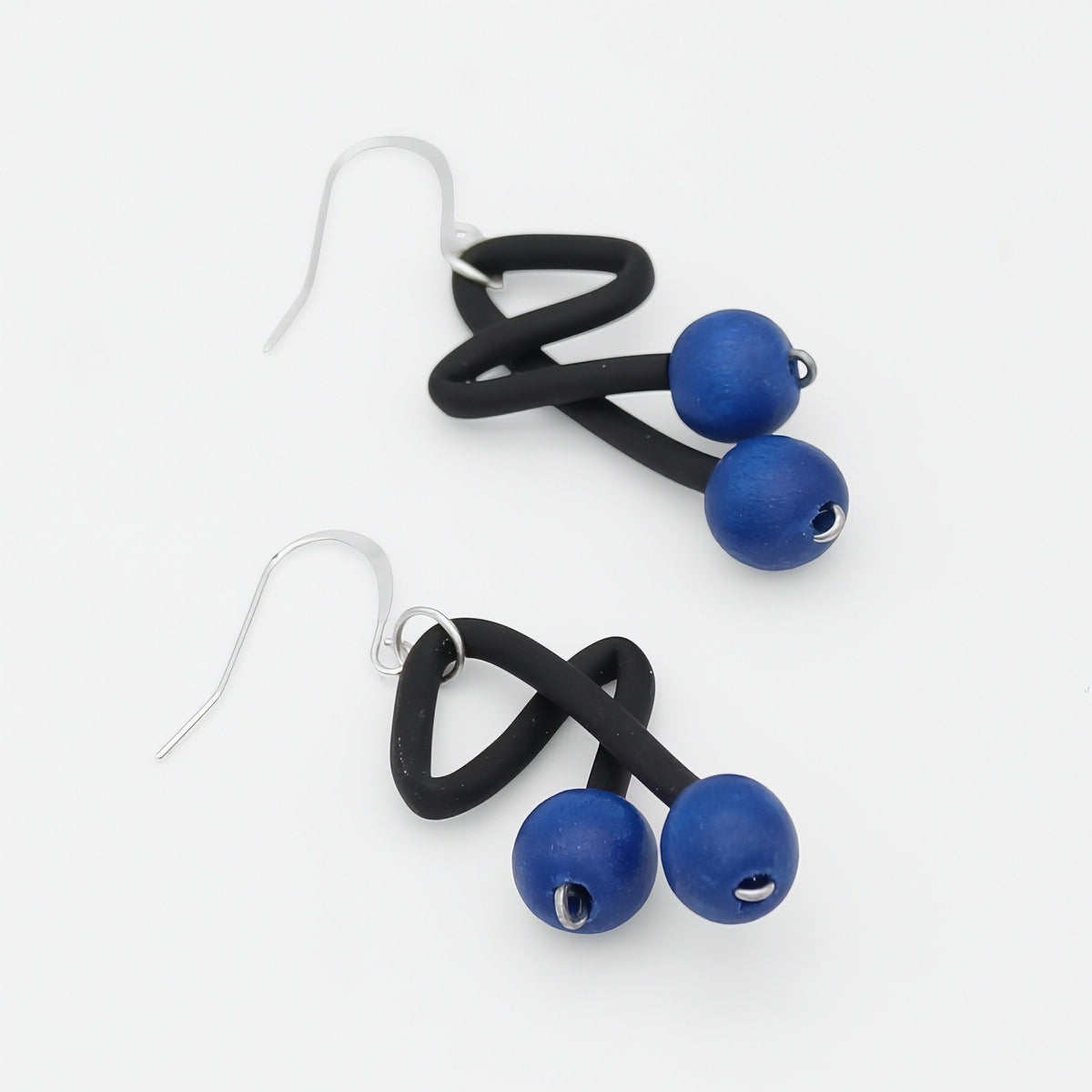 Blue and black artistic drop earrings angled product view