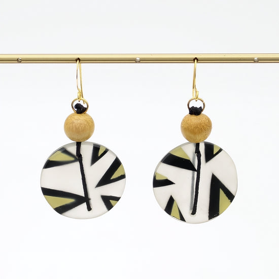 Yellow patterned resin disc earrings hanging display