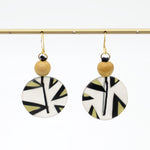 Yellow patterned resin disc earrings hanging display