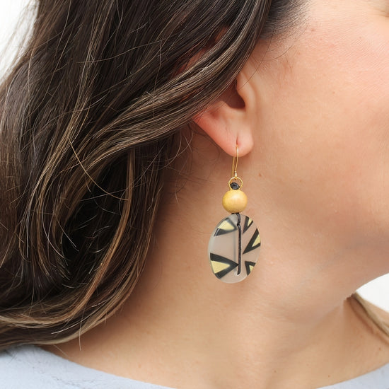 Yellow resin disc earrings shown on model