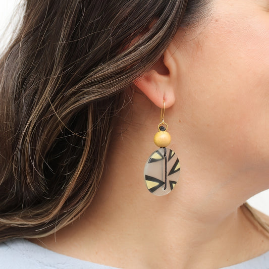 Yellow resin disc earrings shown on model