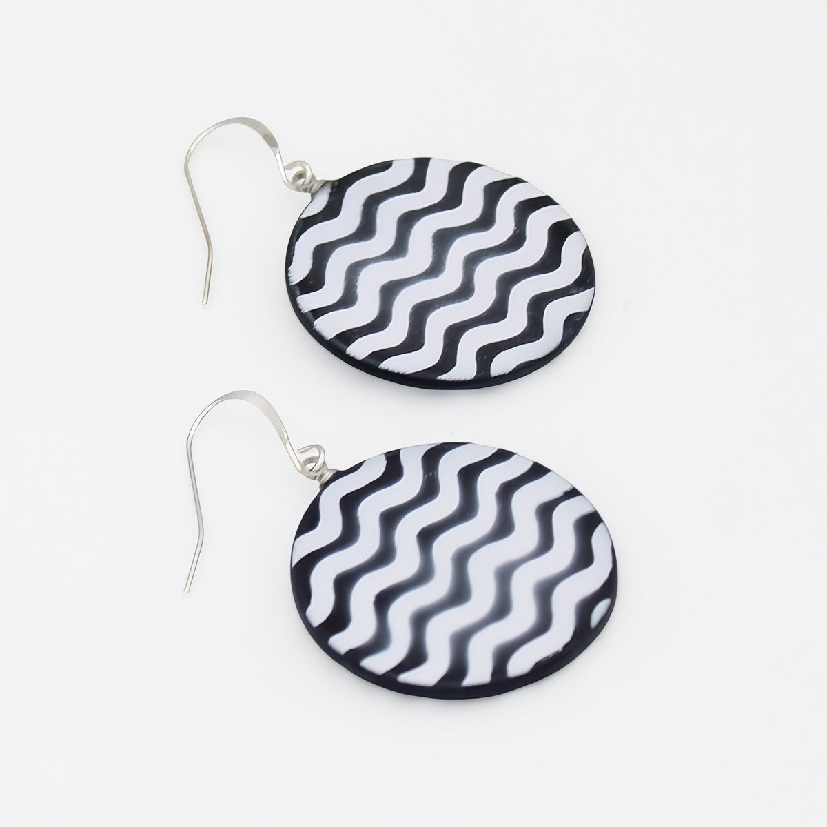 Black and white resin statement earrings angled product view