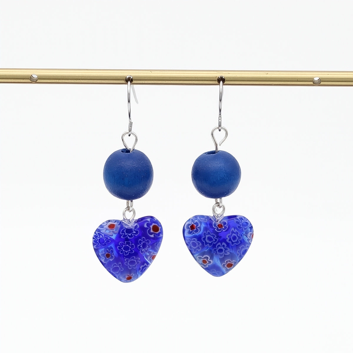 Blue floral heart earrings hanging display