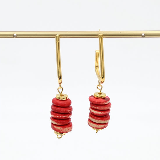Red statement earrings hanging display