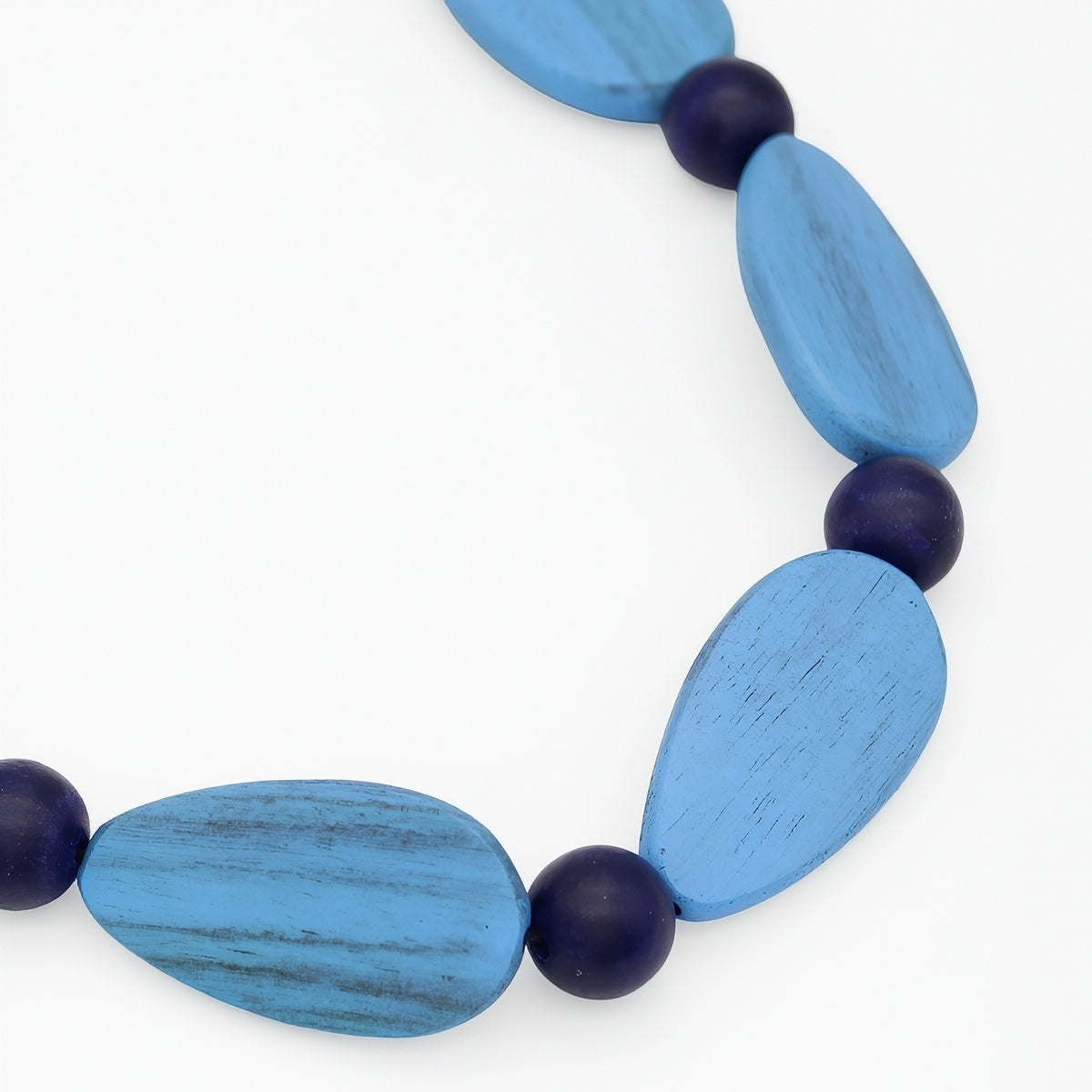 Necklace with blue and purple beads on a white background