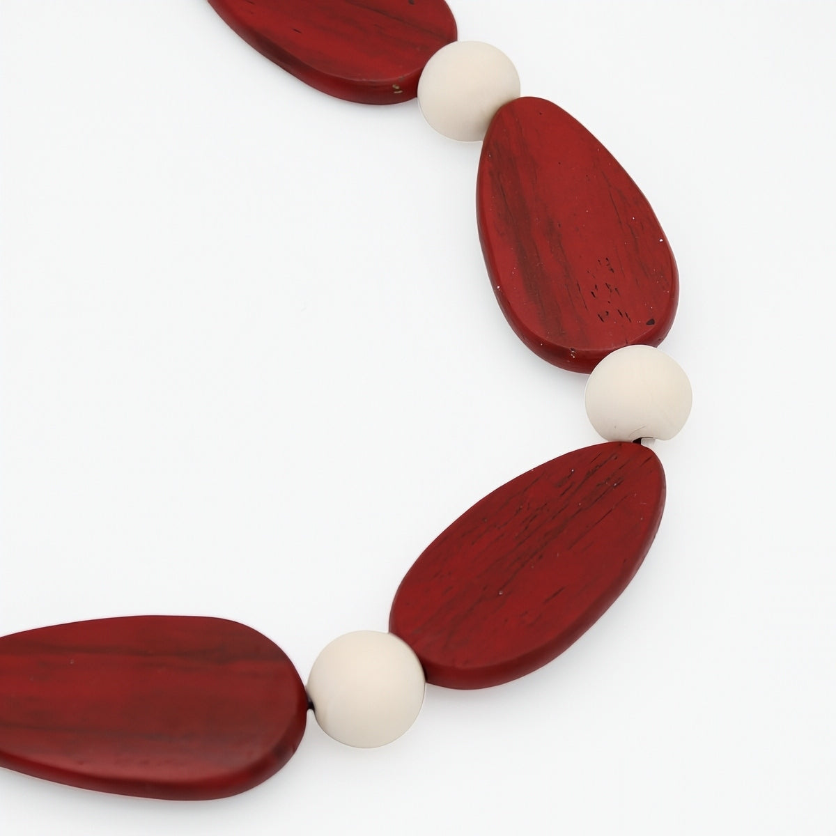 Necklace with red and white beads on a white background