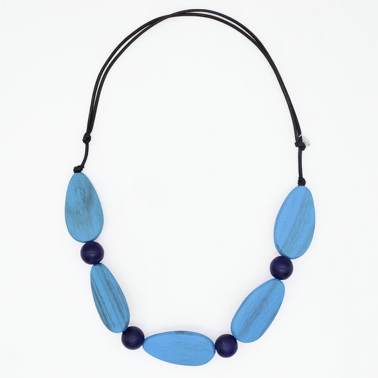 Necklace with blue and purple beads on a white background