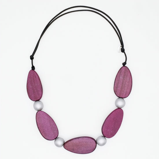 Necklace with pink wooden beads and white pearls on a white background