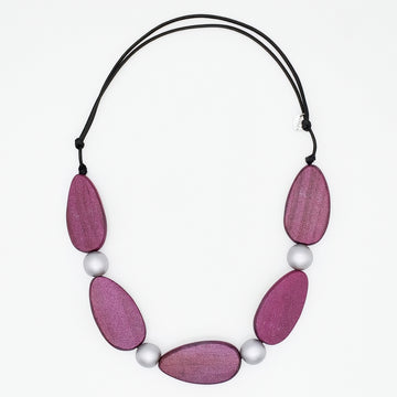 Necklace with pink wooden beads and white pearls on a white background