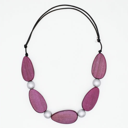 Necklace with pink wooden beads and white pearls on a white background
