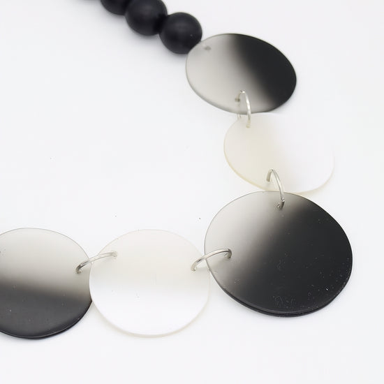 Necklace with round, gradient-colored pendants on a white background