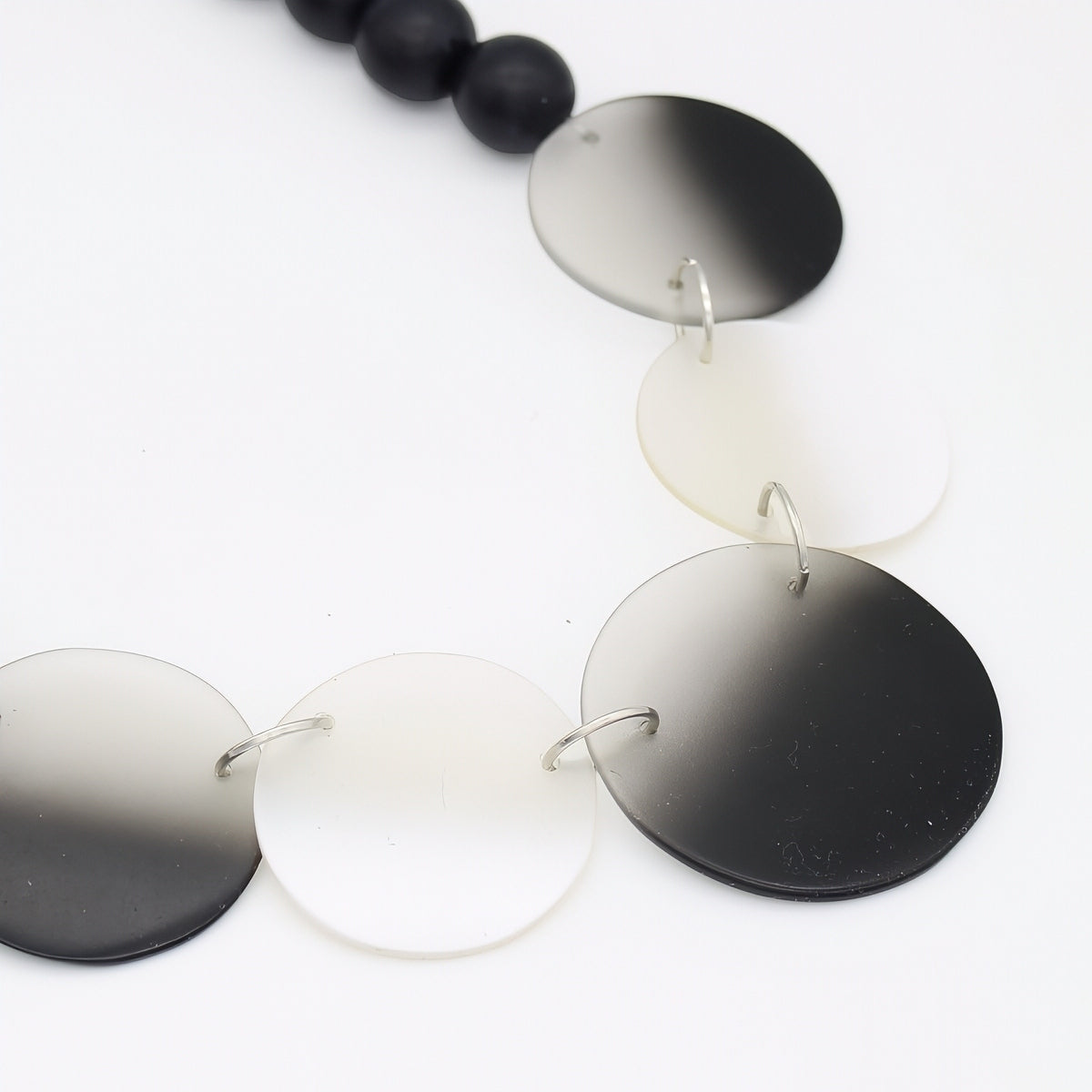 Necklace with round, gradient-colored pendants on a white background