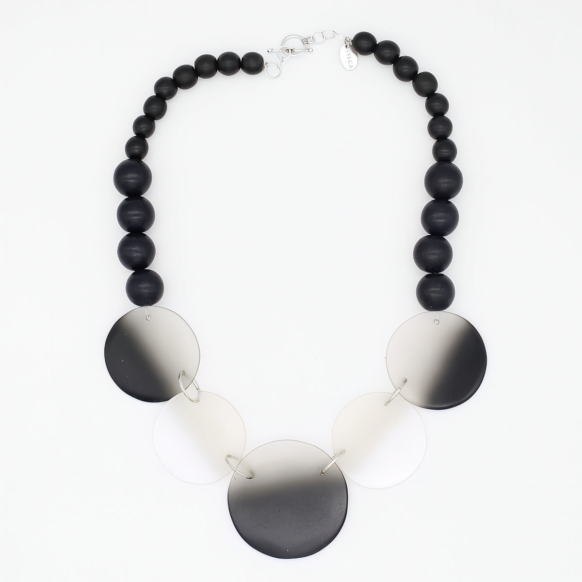 Necklace with black beads and round metallic discs on a white background