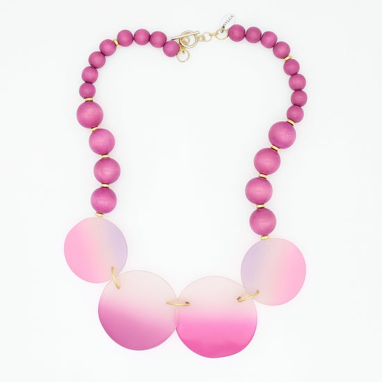 Necklace with pink and white beaded design on a white background