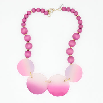 Necklace with pink and white beaded design on a white background