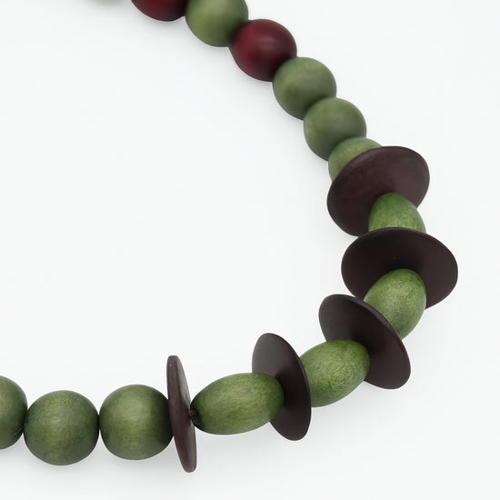 Close up detail of olive green and dark brown wood beads