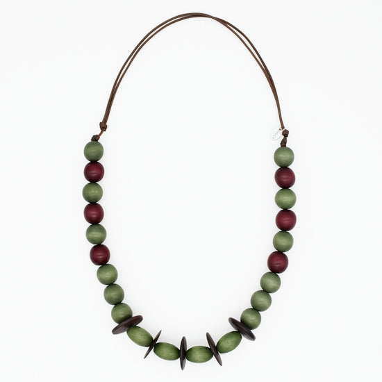 Olive green and burgundy wood statement necklace on white background