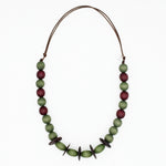 Olive green and burgundy wood statement necklace on white background