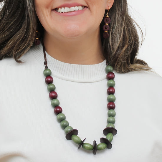 Olive green and burgundy wood statement necklace worn on model