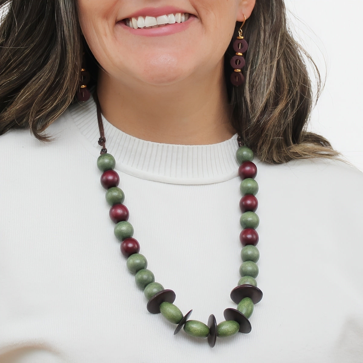 Olive green and burgundy wood statement necklace worn on model