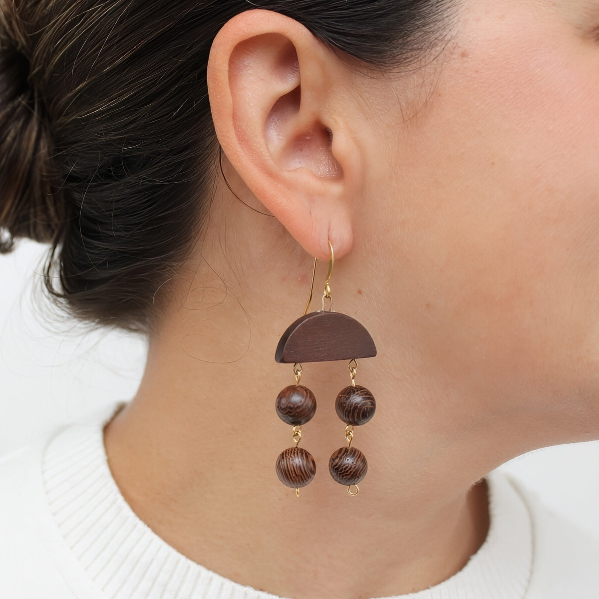 Brown wood statement earrings shown on model