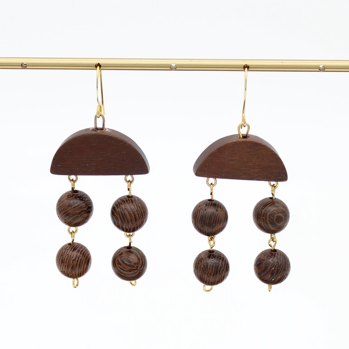 Brown wood statement earrings with dangling round wood beads