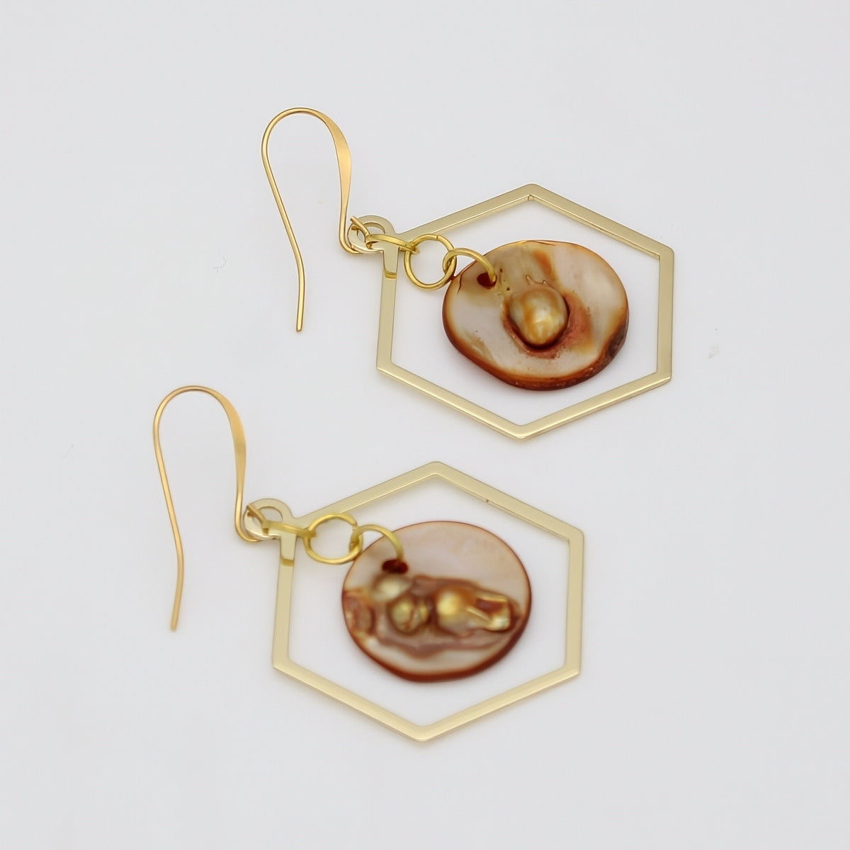 Gold geometric resin earrings angled product view