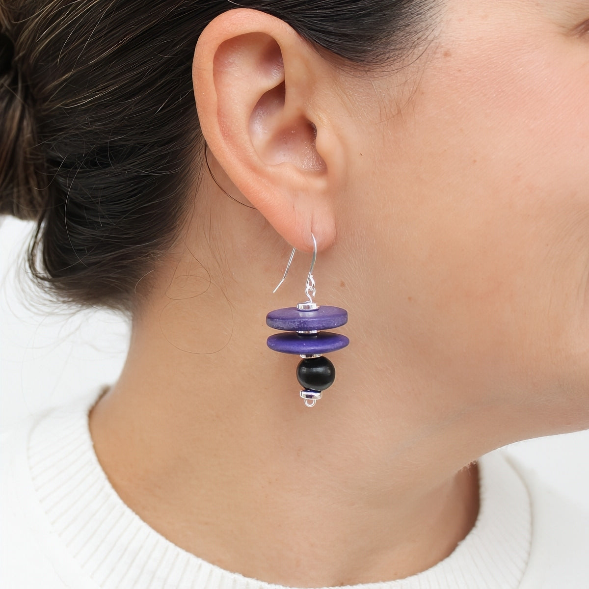 Purple and black wood statement earrings shown on model