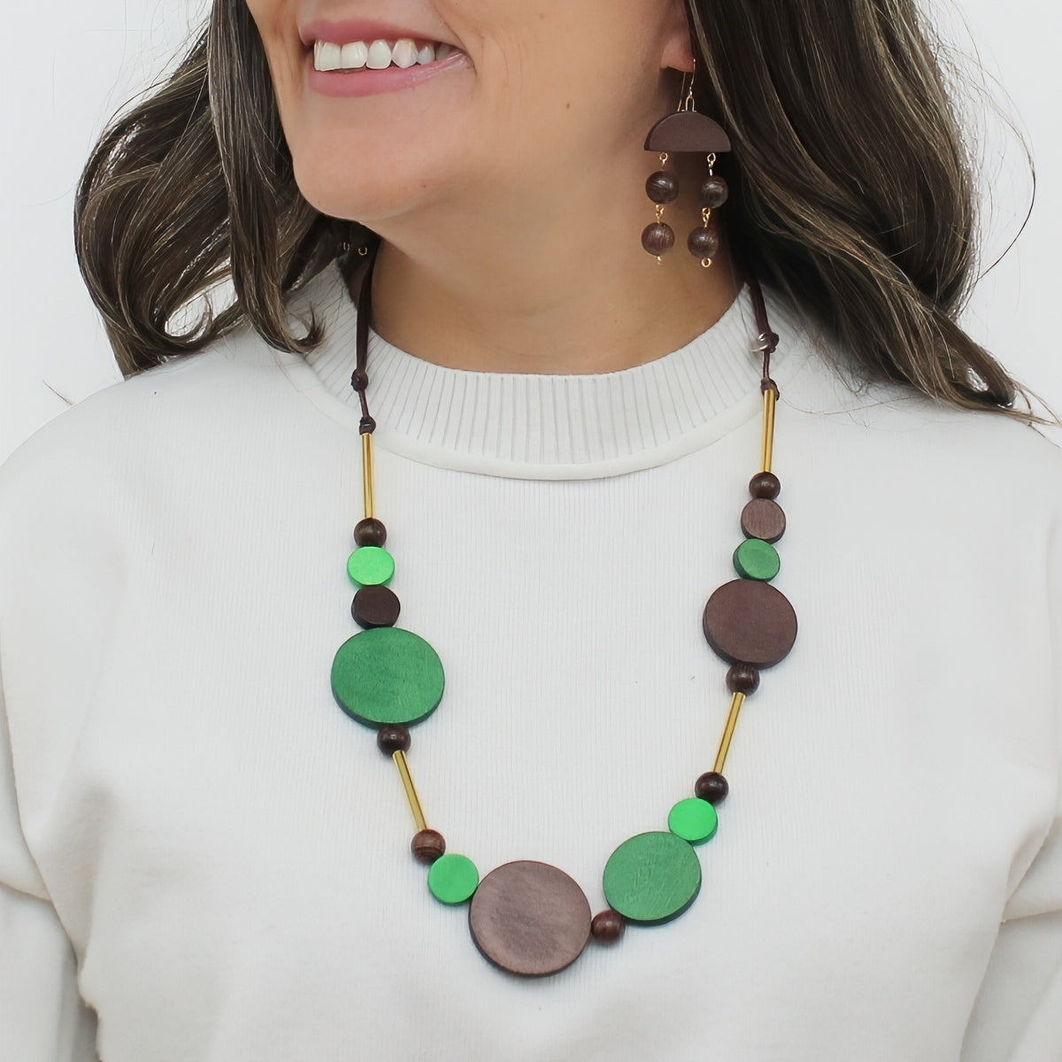 Green and brown wood circle statement necklace worn on model