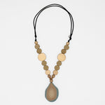 Taupe and gold wood statement necklace with layered resin pendant on white background