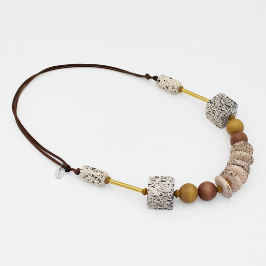 Natural wood statement necklace with speckled cream beads and gold accents angled view