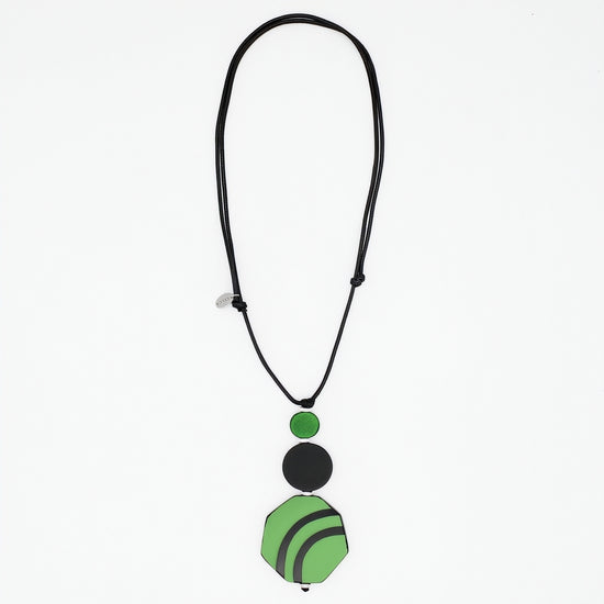 Green and black resin and wood pendant necklace on white background