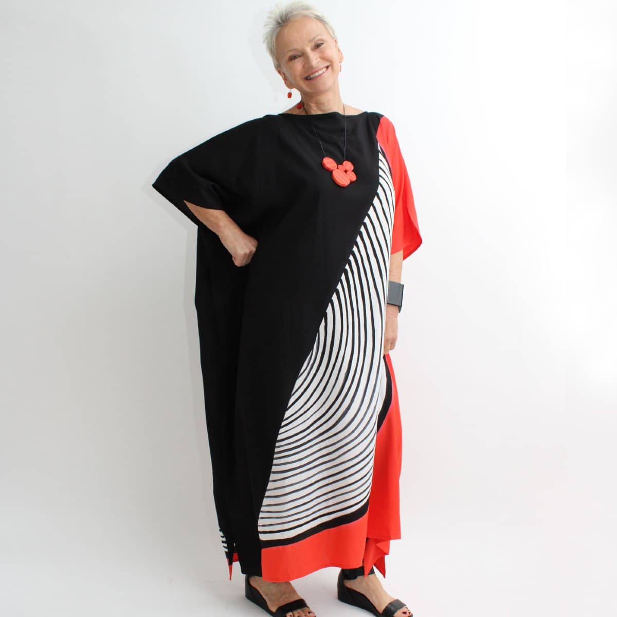 woman wearing red, black, white half circle maxi dress caftan