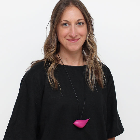 woman wearing pink bird necklace