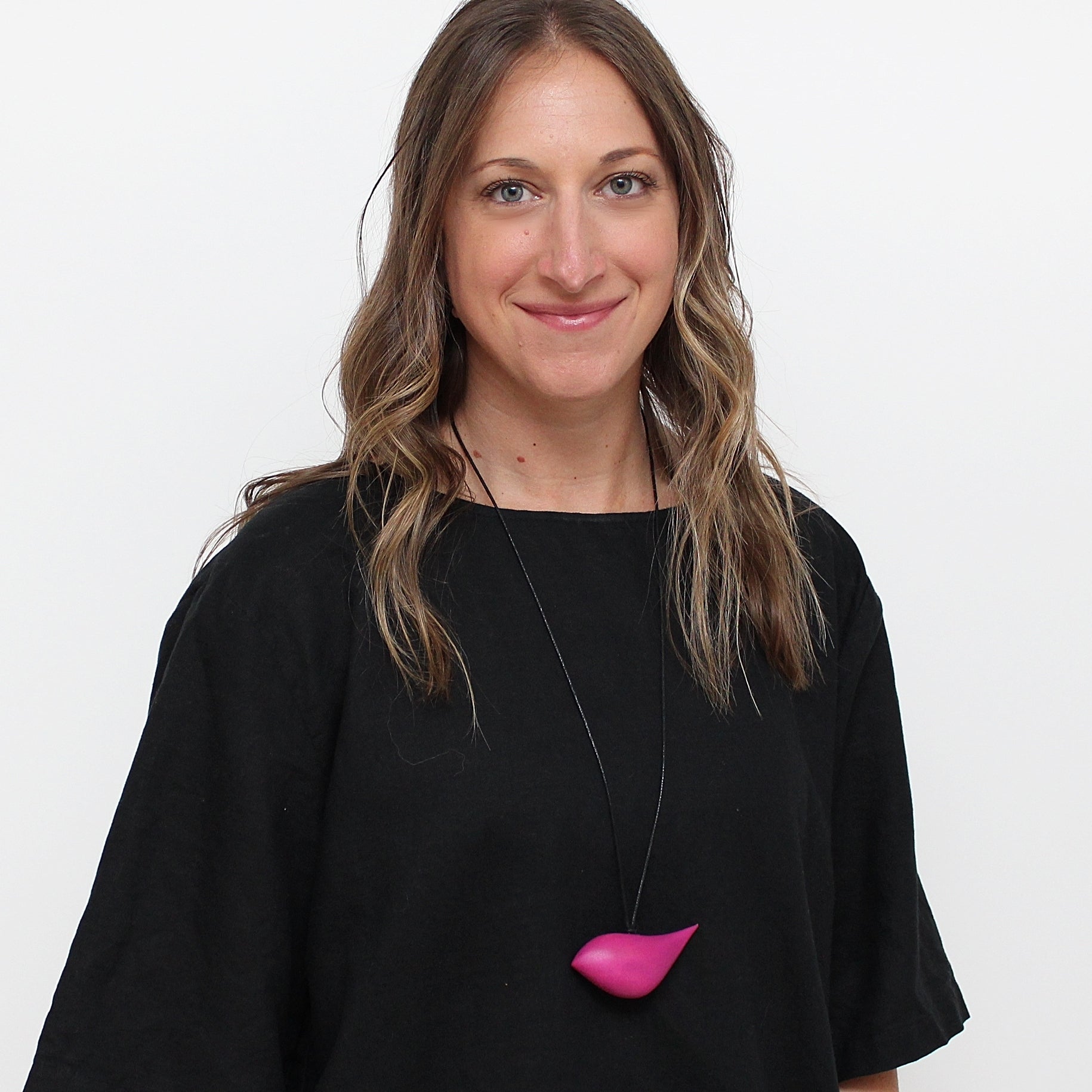 woman wearing pink bird necklace