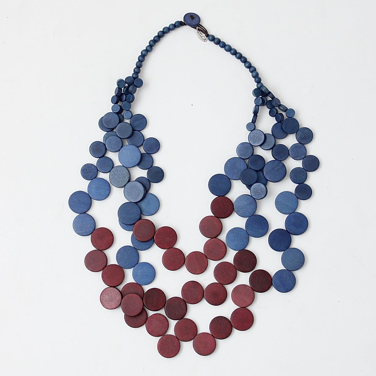 One of our favorite layered necklaces, made of carefully handcrafted wood, is back in beautiful new colorway of purple and blue.